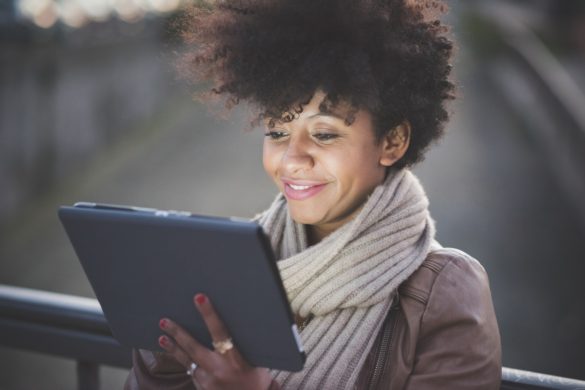 beautiful black curly hair african woman using tablet